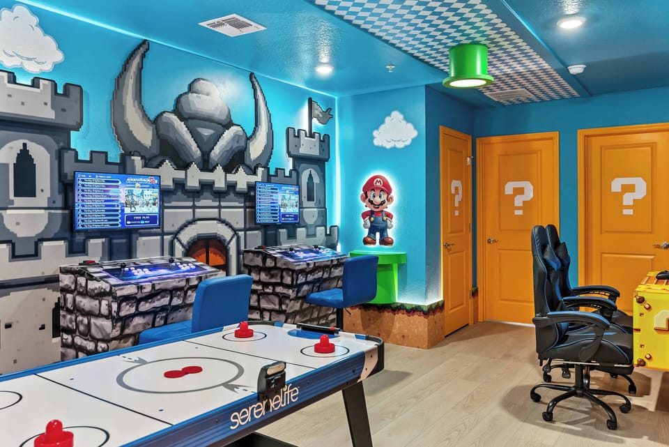 Experience a lively game room filled with fun and creativity, highlighted by a stunning blue castle mural. Enjoy friendly competition on the air hockey table and unwind in cozy gaming chairs for endless entertainment.