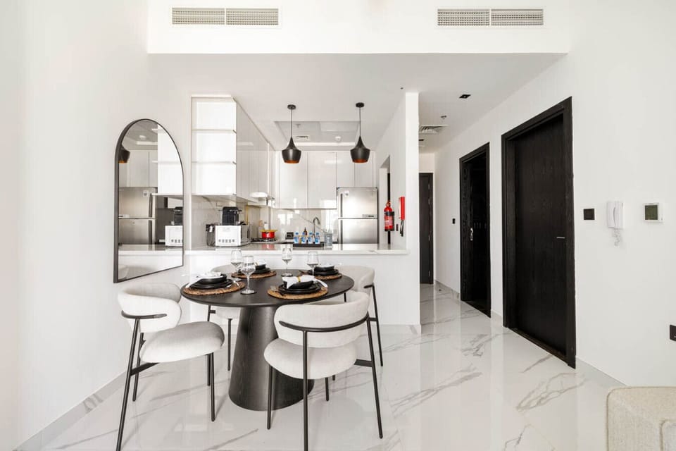 Sleek open-plan dining with a modern kitchen setup