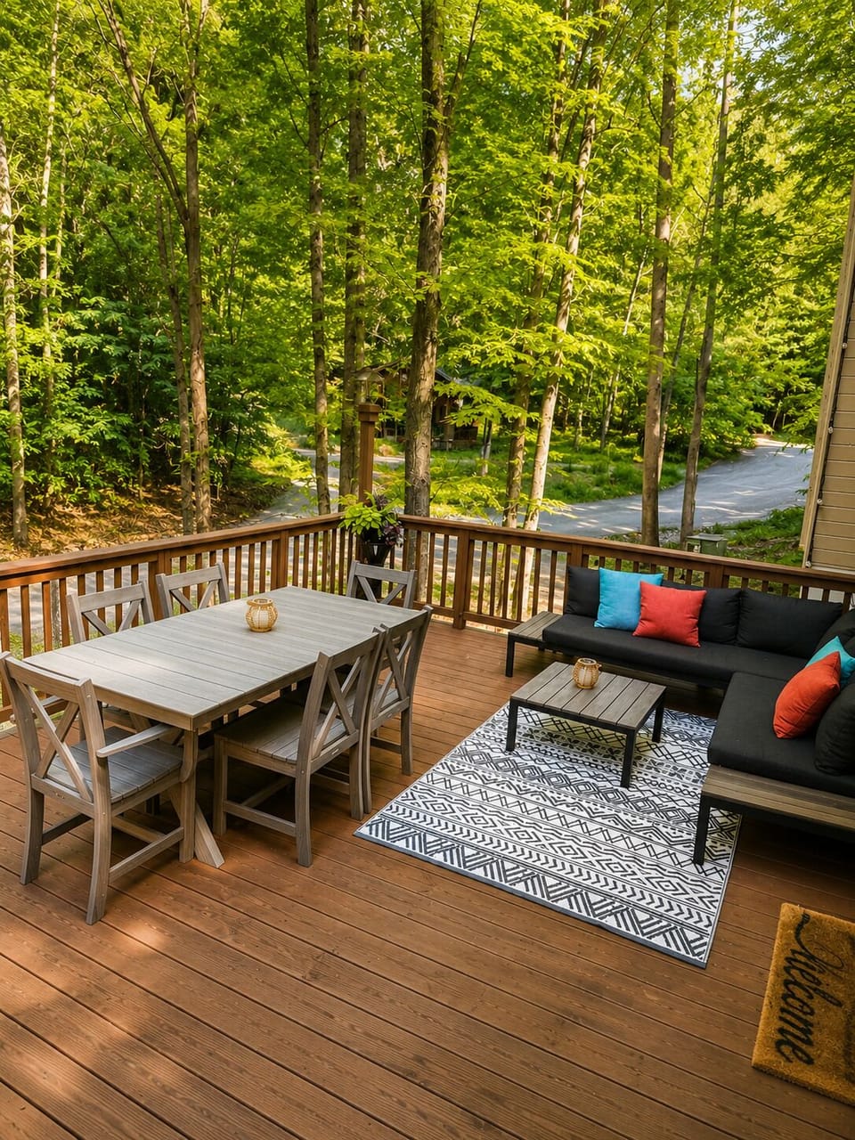 Spacious wooded deck with outdoor dining and lounge seating—perfect for morning coffee, group meals and relaxing among the trees.