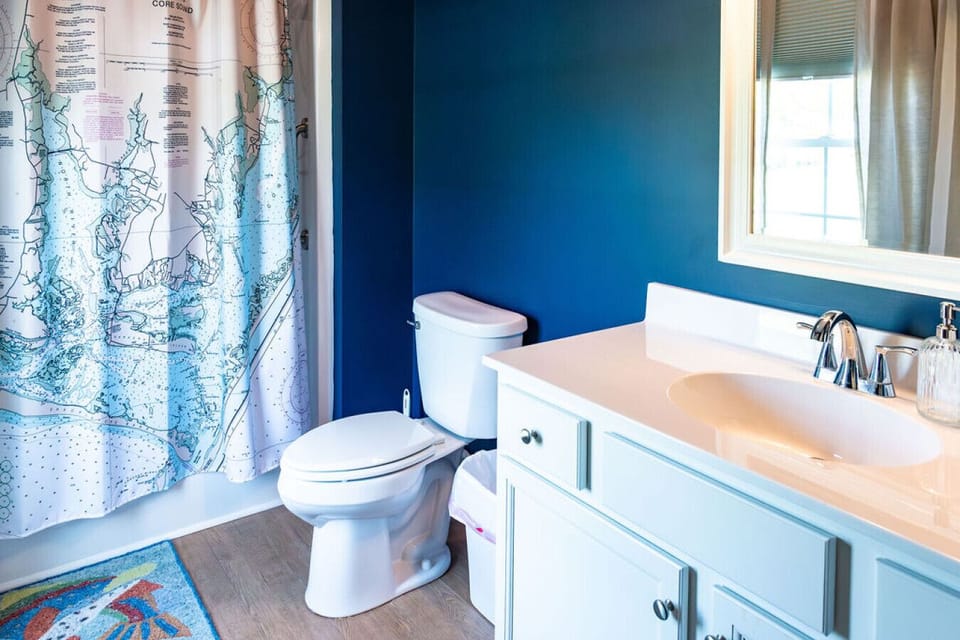 Primary bathroom featuring a shower curtain, vanity, and modern fixtures for added comfort and convenience