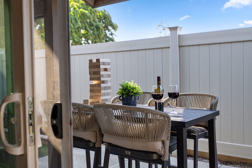 Outdoor Dining: Relaxed setup with table and chairs, perfect for alfresco meals