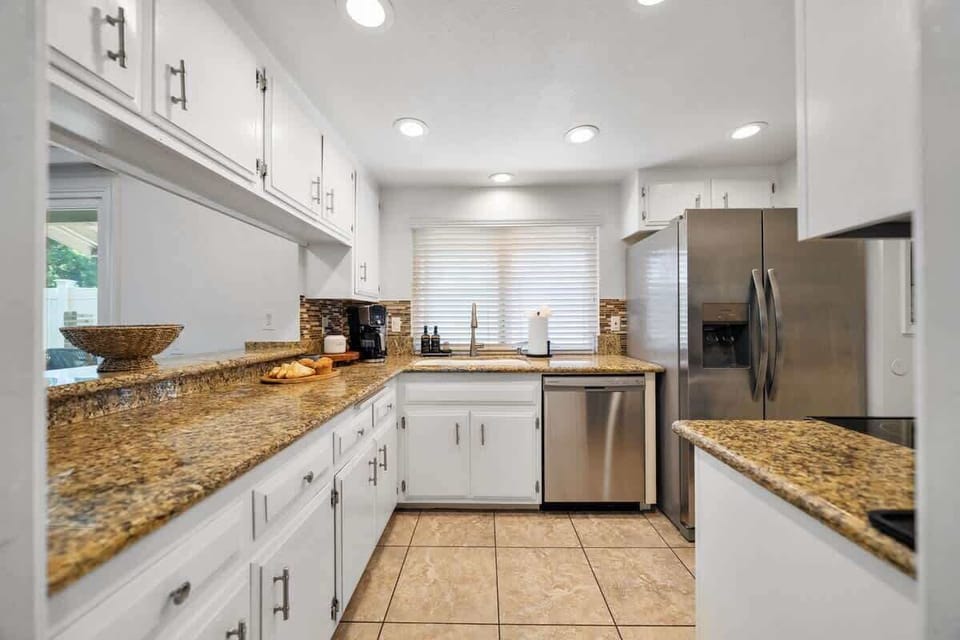 Kitchen: Spacious and fully equipped with modern appliances, cookware, and dinnerware, perfect for preparing home-cooked meals and enjoying family gatherings with ease.
