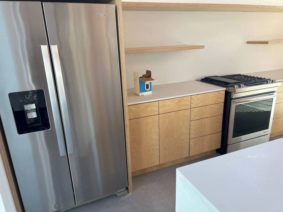 Kitchen counter area stove and refrigerator