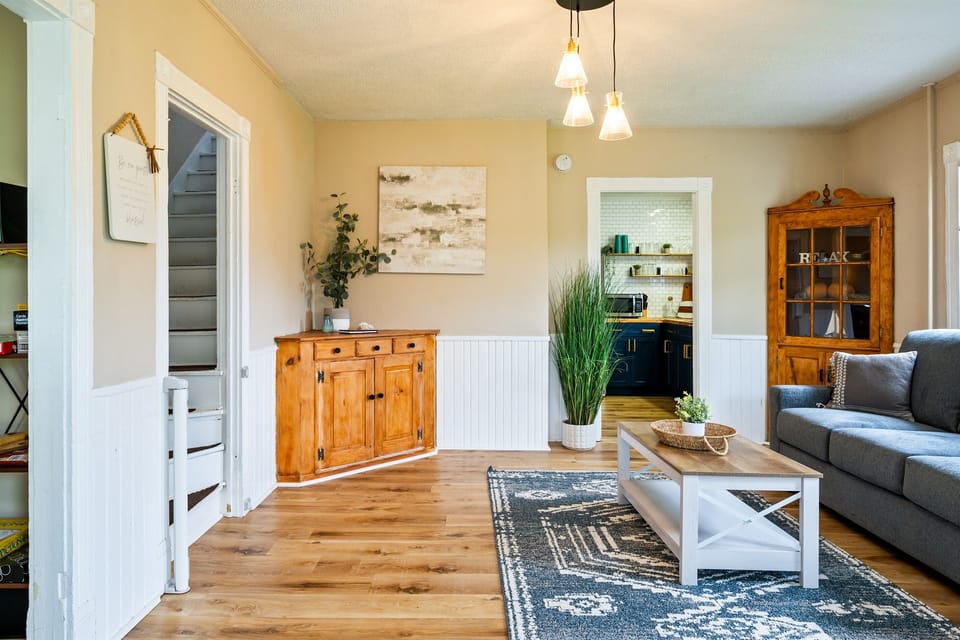 Charming living room with stylish wood accents and an open view into a beautifully updated kitchen — perfect for relaxing or entertaining. 🛋️✨