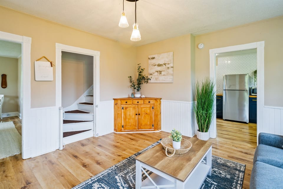 Charming living room with stylish wood accents and an open view into a beautifully updated kitchen — perfect for relaxing or entertaining. 🛋️✨