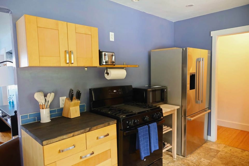 Stylish and modern kitchen with modern appliances, unique decor, and a spacious dining area perfect for hosting gatherings or cooking with loved ones