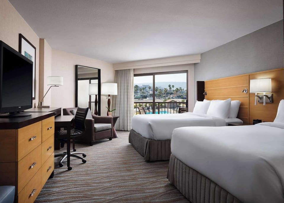 Unwind together in a bright room with balcony breezes.