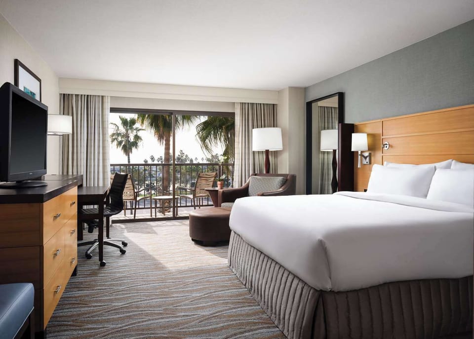 Unwind in a sunlit room with breezy balcony views.