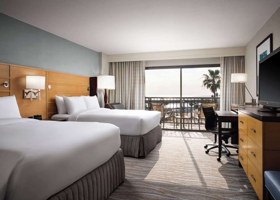 Stretch out in a double-queen room with balcony scenery.