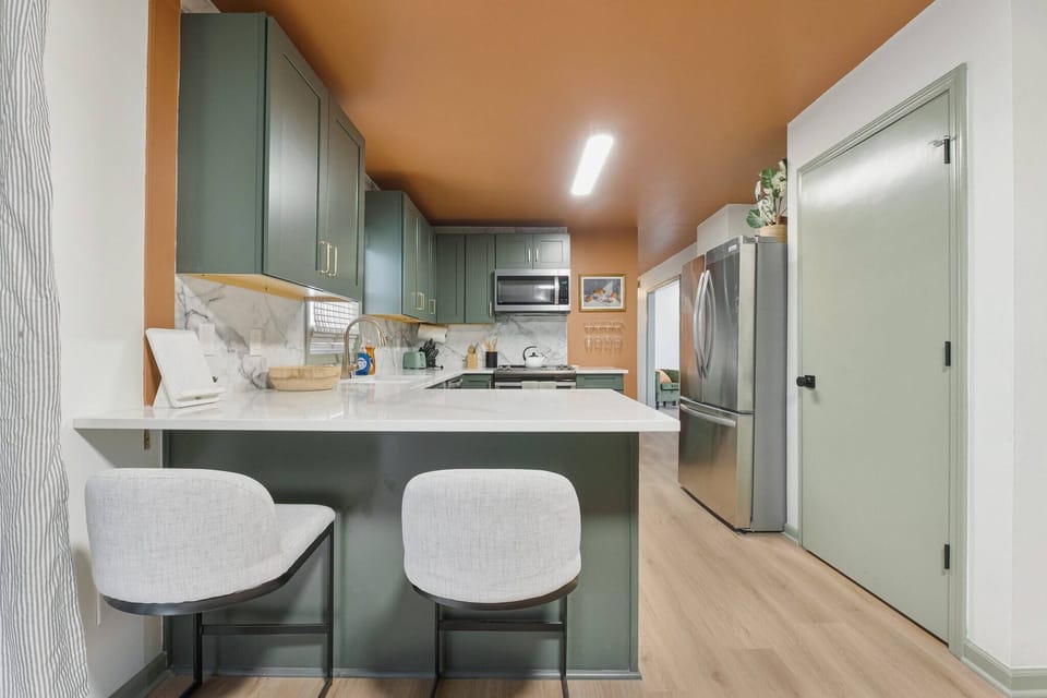 Fully equipped kitchen with additional countertop seating. 