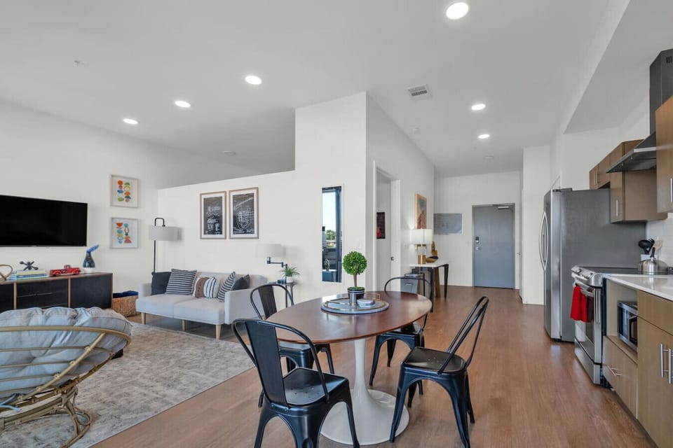 - Open plan living and dining area with floor to ceiling windows   - Chic furnishings smart TV and high speed WiFi for remote work   - Luxury city apartment with balcony and abundant sunlight