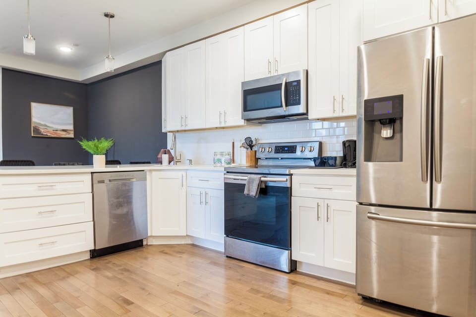 Fully equipped kitchen with all essentials, including a stove, fridge, microwave, and coffee maker—perfect for home-cooked meals.