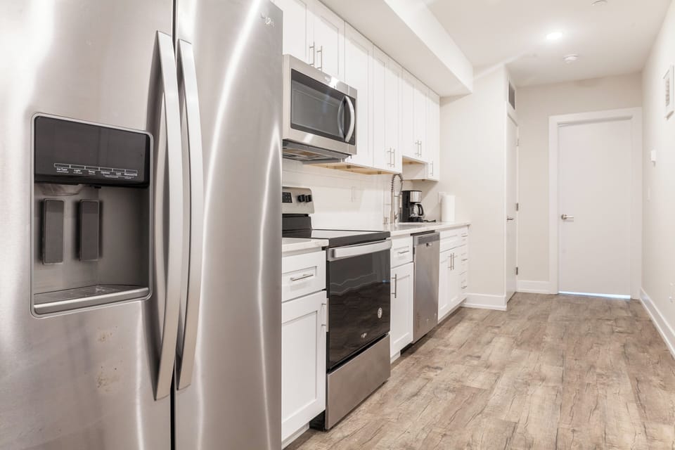 Enjoy the open layout while preparing meals. Modern appliances, ample space, and a dining area with a view make cooking a pleasure.