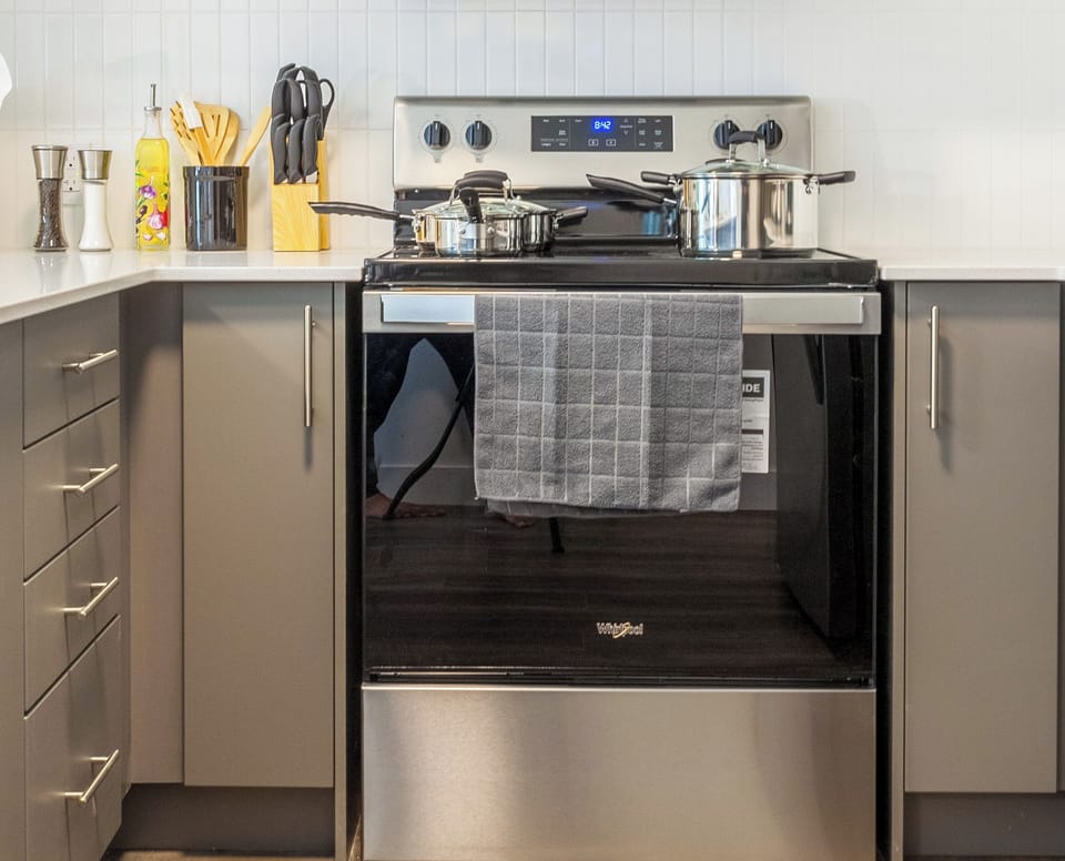 Fully equipped kitchen with all essentials, including a stove, fridge, microwave, and coffee maker—perfect for home-cooked meals.