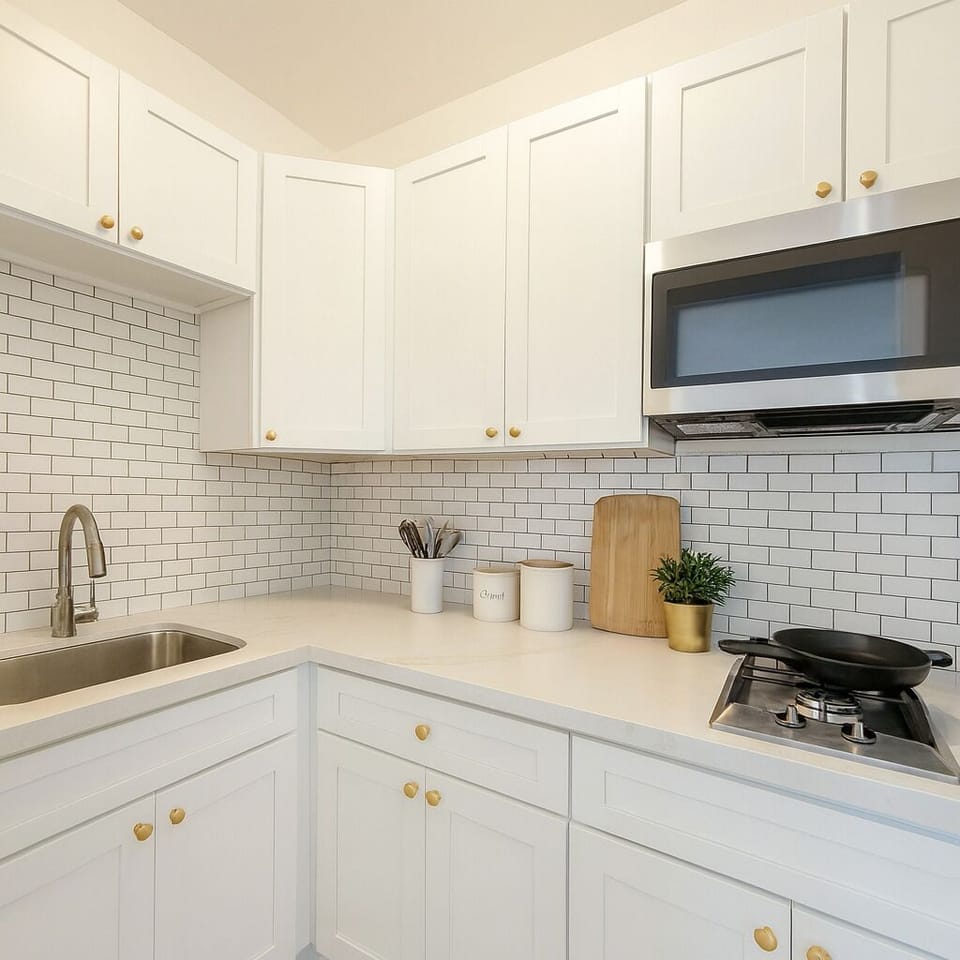 Fully stocked kitchen with stainless appliances and modern cabinetry.