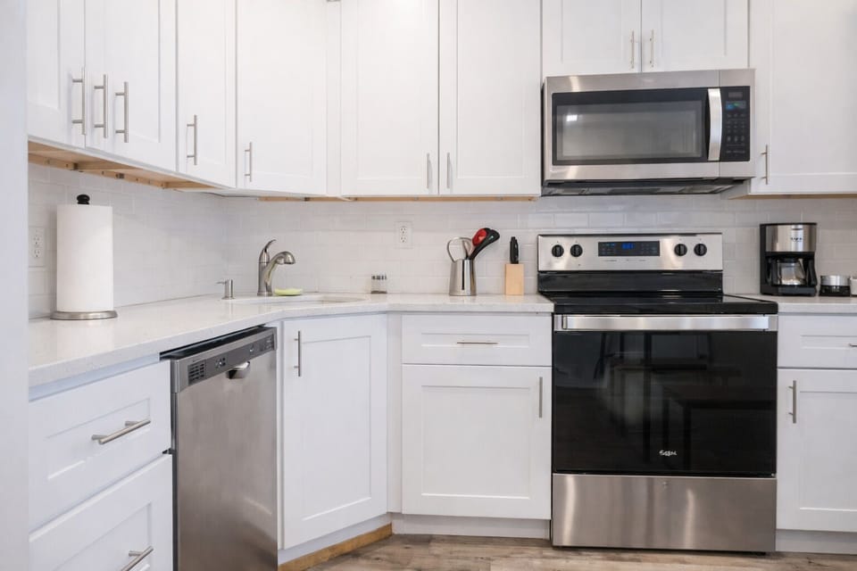 Modern kitchen with sleek countertops and all essential cooking amenities.