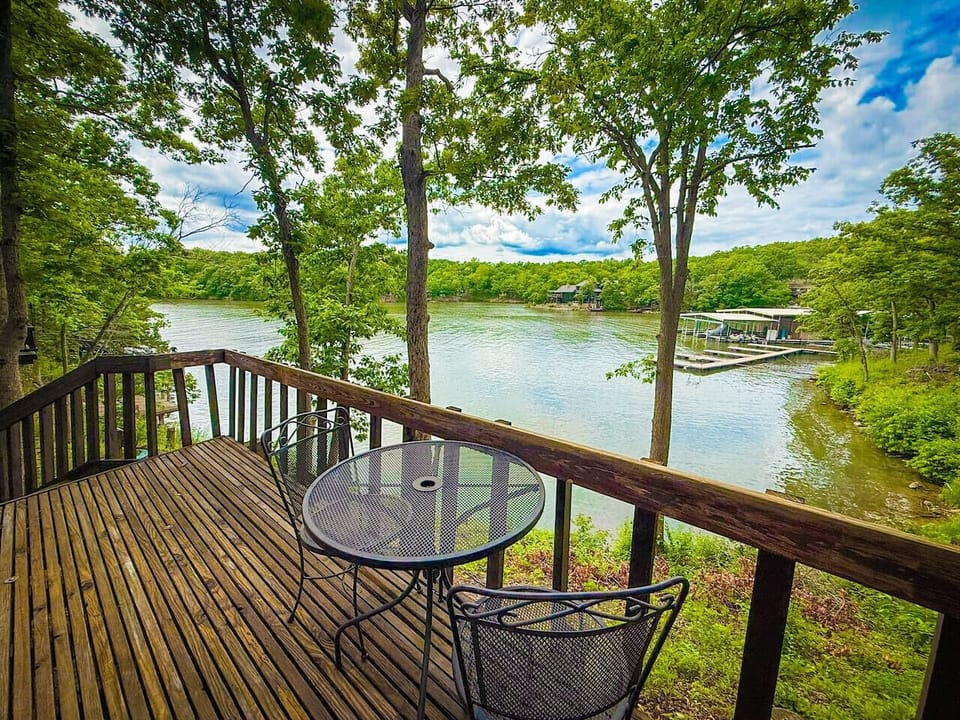 Savor your morning coffee or evening cocktails on the private deck of Unit 20, offering stunning views of the tranquil lake and surrounding nature.