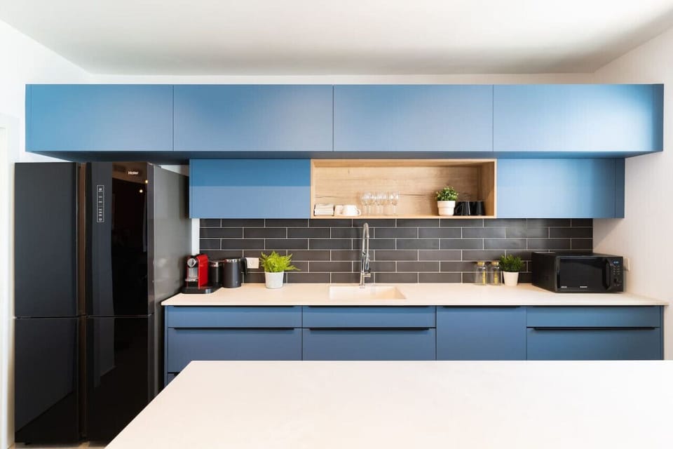 Kitchen counter, sink, microwave, refrigerator