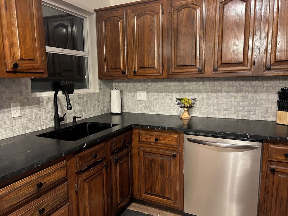 Fully stocked updated kitchen with dishwasher and large refrigerator.