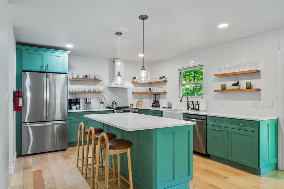 Modern kitchen with island seating and warm wood details.