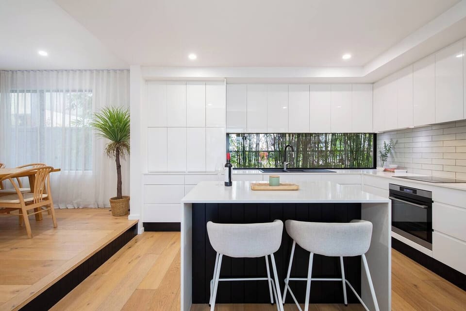 A seamless flow between the dining area and open-plan kitchen allows for easy meal prep and lively conversation, surrounded by elegant finishes and natural light.