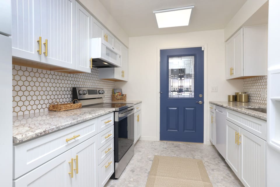 kitchen with view of door to carport