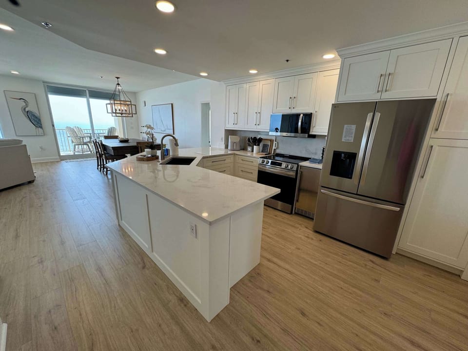 large kitchen with new appliances and a pantry to store groceries 