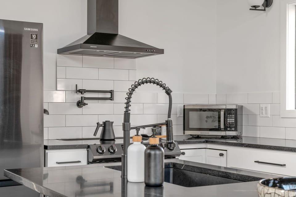 Open kitchen with breakfast bar and full amenities.
