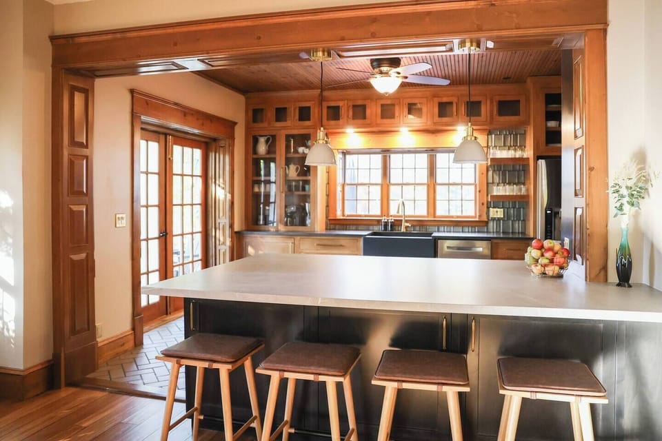 The kitchen has full-size appliances and a hidden induction cooktop located on the island. Counter seating for 4.