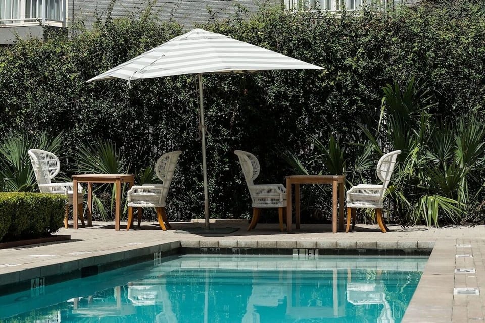 Unwind poolside under shade, sipping something cool and quiet.