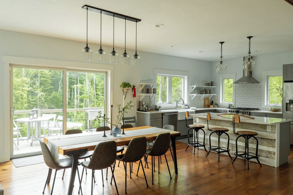 Farmhouse dining table offers meals with forest views from every seat.