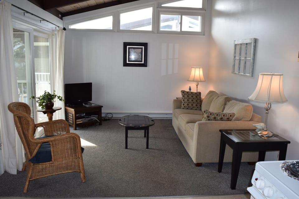 Inviting Livingroom with flat screen tv is open to the kitchen and dining area
