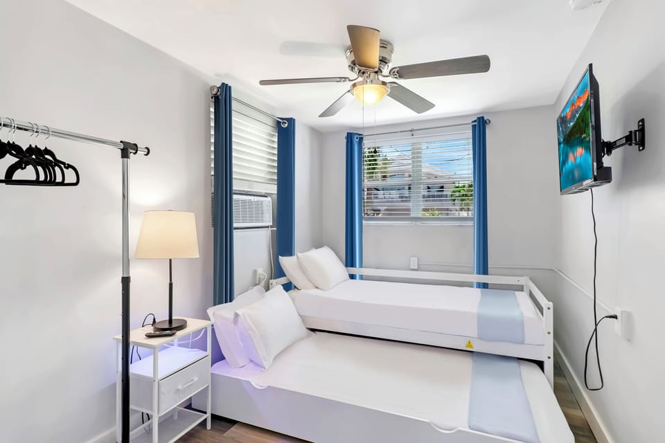 Bay Escape Home | Cozy bedroom with two twin trundle beds and a 32" smart TV.