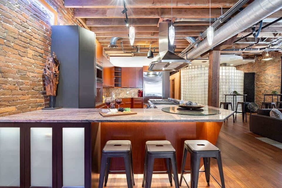 Fully Equipped Kitchen featuring stainless steel, open counter space, and bar seating for 3 guests.