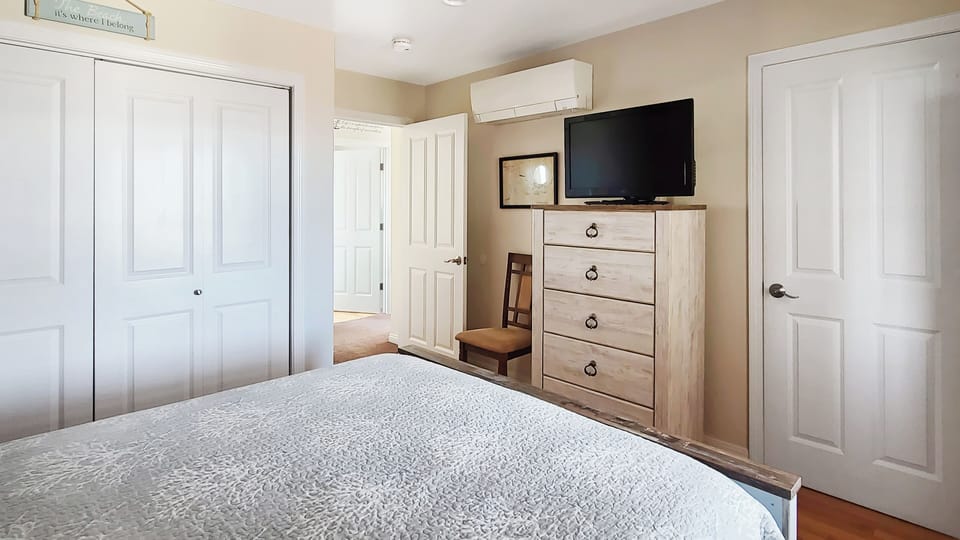 Bedroom two with queen bed and TV