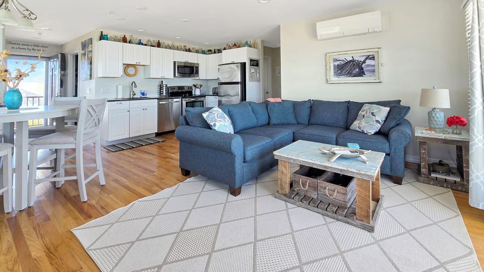 Living room with dining area and kitchen beyond