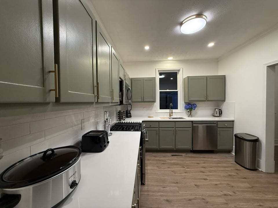 Modern, fully equipped kitchen with sleek cabinets and bright lighting.