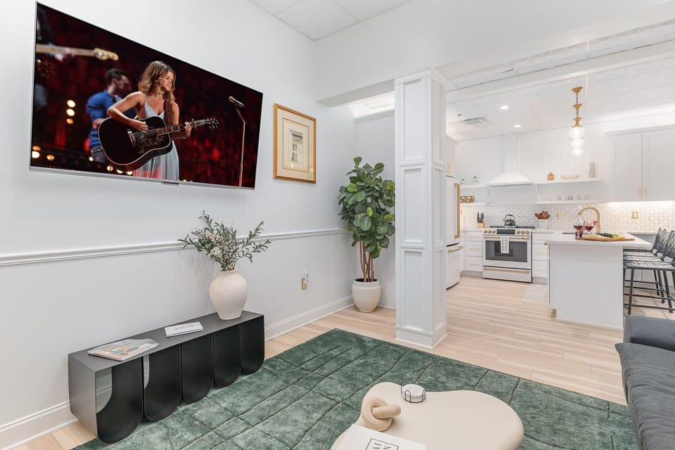 Unit 1: Open-Concept Living Area featuring designer furnishings, and a Smart TV.