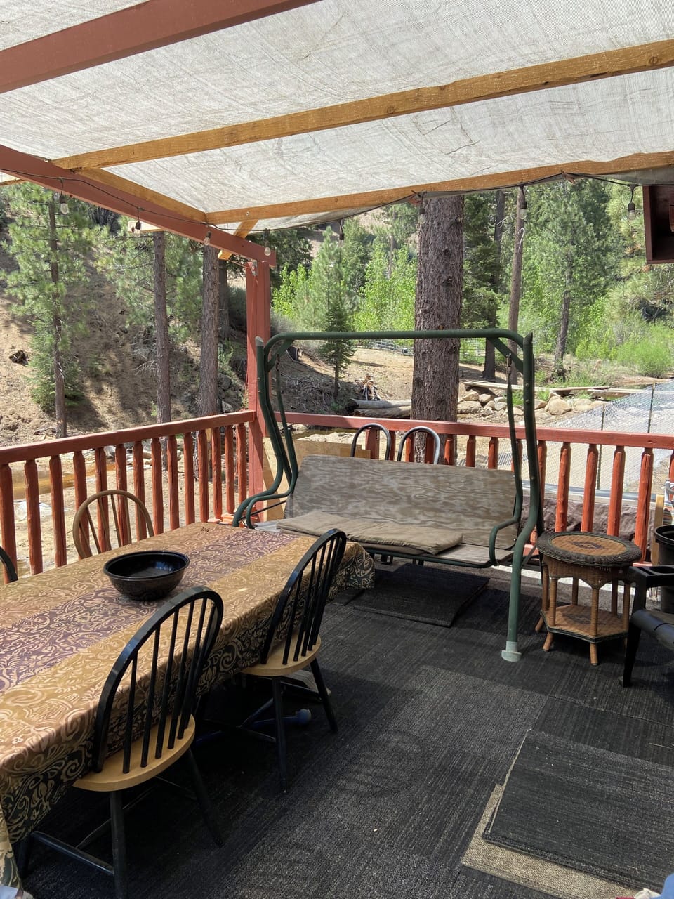  large fourteen by twenty foot deck surrounded by pine trees