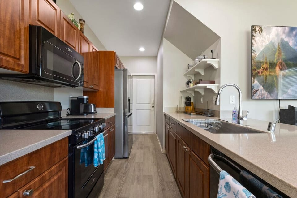 Well-appointed kitchen featuring abundant cabinet space and convenient appliances, including a Nespresso machine and blender—ideal for everyday convenience.