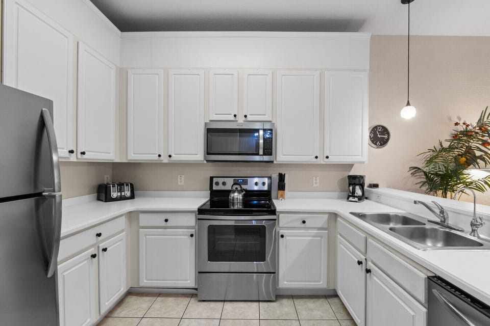 Fully equipped kitchen with stainless steel appliances.