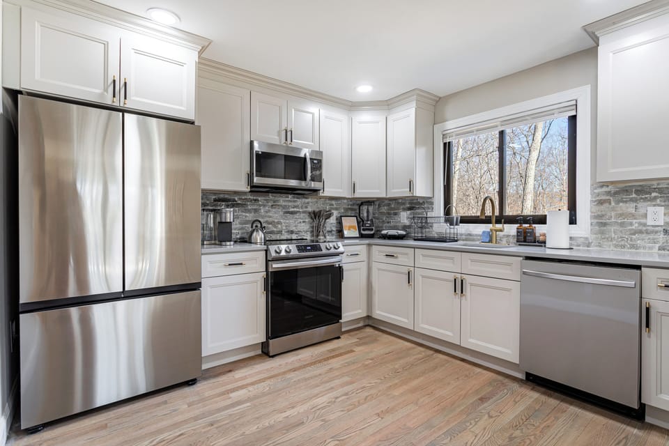 Modern kitchen with stainless steel appliances.