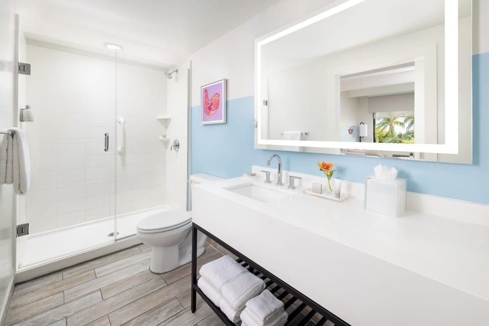 Rinse off effortlessly in a sleek, glass-walled shower.