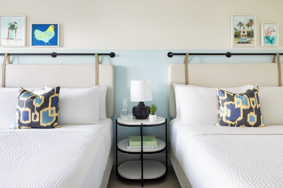 Sink into crisp linens beside charming coastal artwork and lamps.
