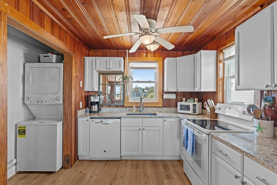 Kitchen with granite countertops, washer, and dryer.
