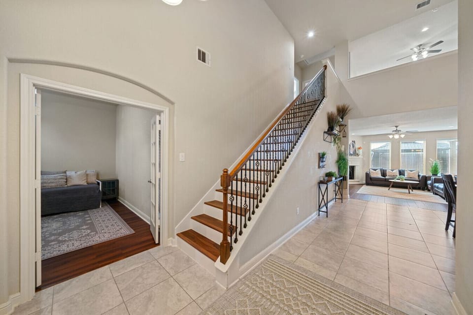 Spacious entry with stairs and a welcoming lounge.