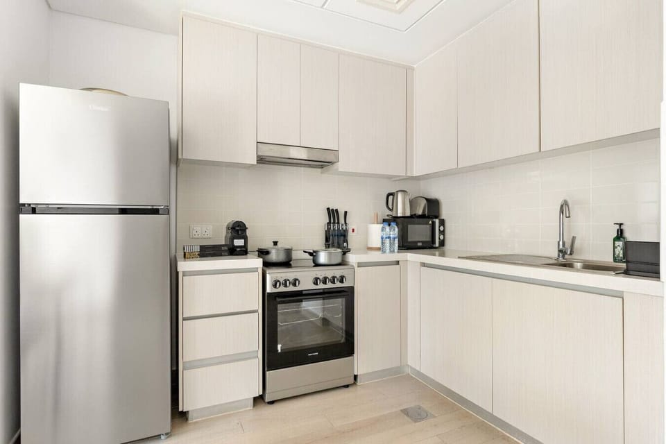 Modern Kitchen: Sleek appliances and ample space make meal prep a delight in this stylish kitchen!