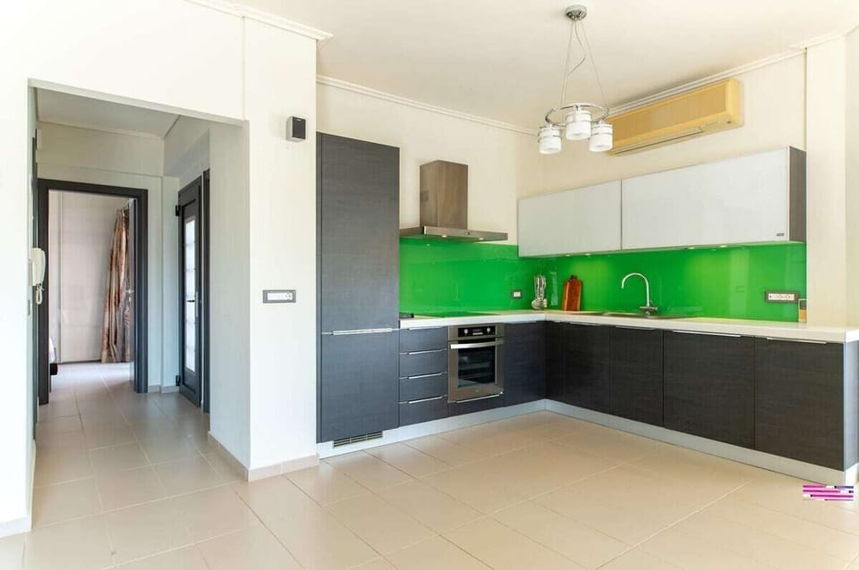 Spacious, modern kitchen with vibrant design, fully equipped for home cooking.