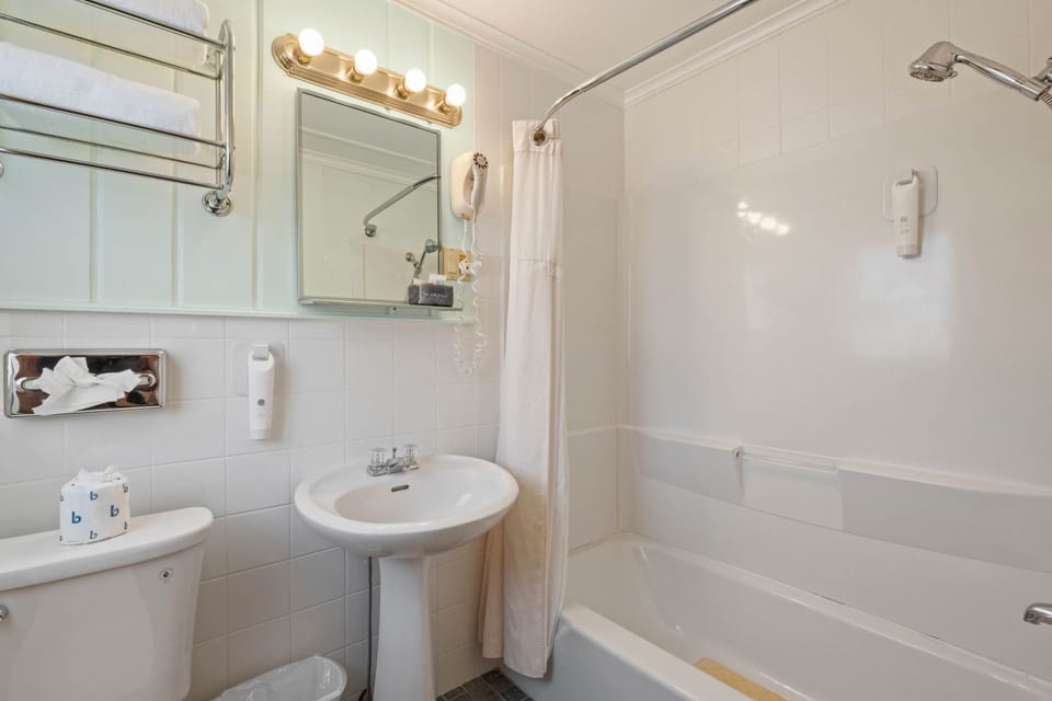 Clean and classic, the private bathroom includes a full shower and fresh towels.