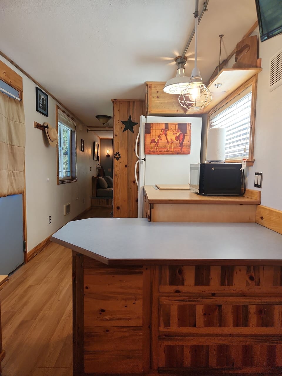 Everything you need for cooking in a kitchen area with full size refrigerator.